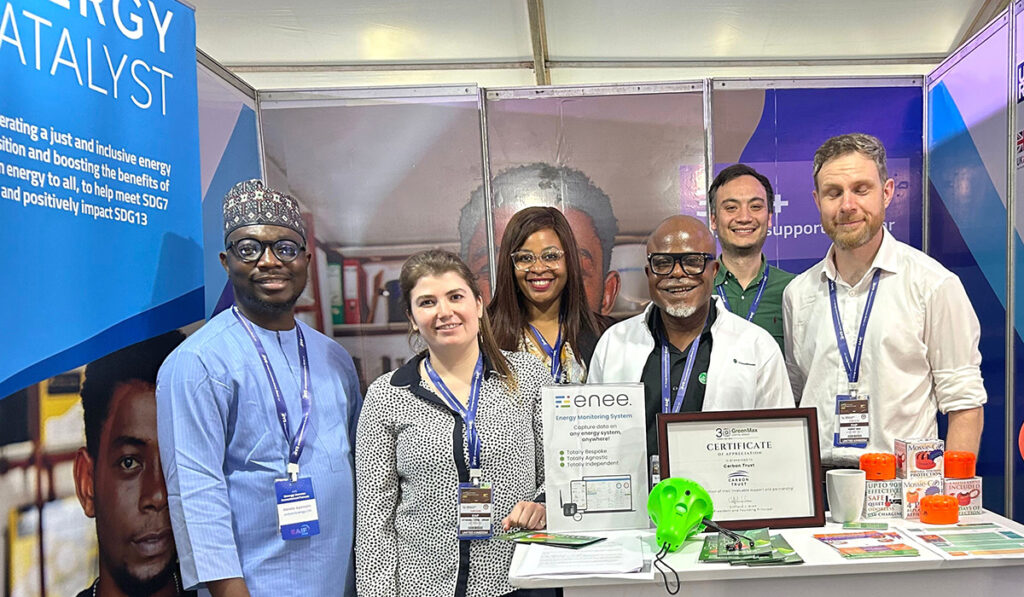 Members of the Energy Catalyst team posing for a photograph with clean energy innovators at EAIF